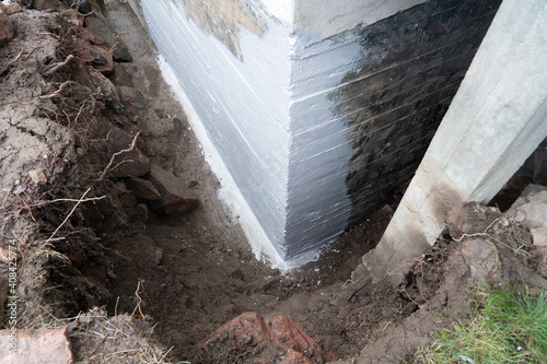 Waterproofing foundation of an old house.