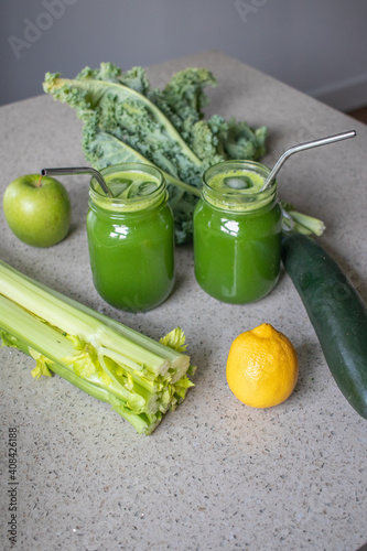 Green Juice with fresh produce on countertop 
