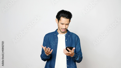 Fotografia Stress asian man struggle with mobile phone, Frustrated asia male holding smartp