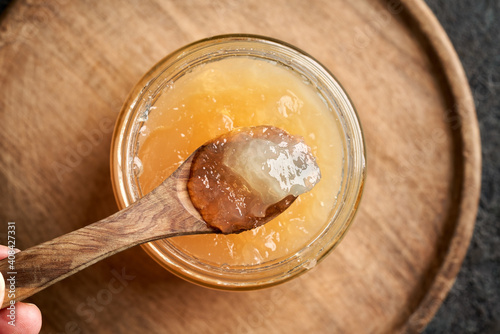 Cooled congealed beef bone broth on a wooden spoon photo
