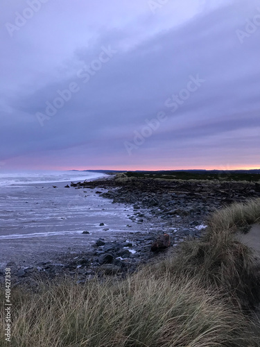 Oregon Coast beautiful sunrise at rocky beach, vertical image photo