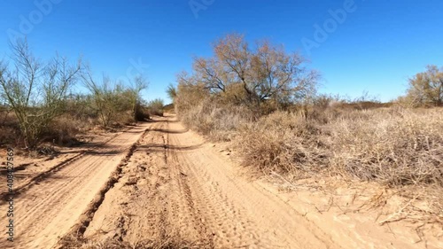 Rocky and sandy trail road in rural desert shot at speed hyperlapse POV