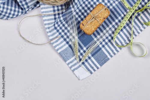 Biscuits and tape measure on a white background with tablecloth