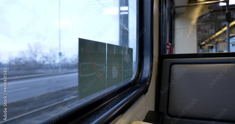 Seat window on the moving train cross the river on the bridge and view of cityscape of Düsseldorf, Germany through window. Enjoy outdoor scenery moment during journey and travel by train. 