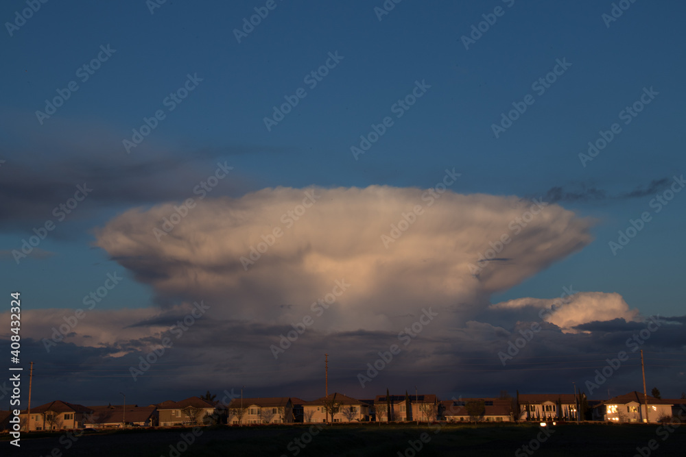 Cloud formation from a gathering storm over houses