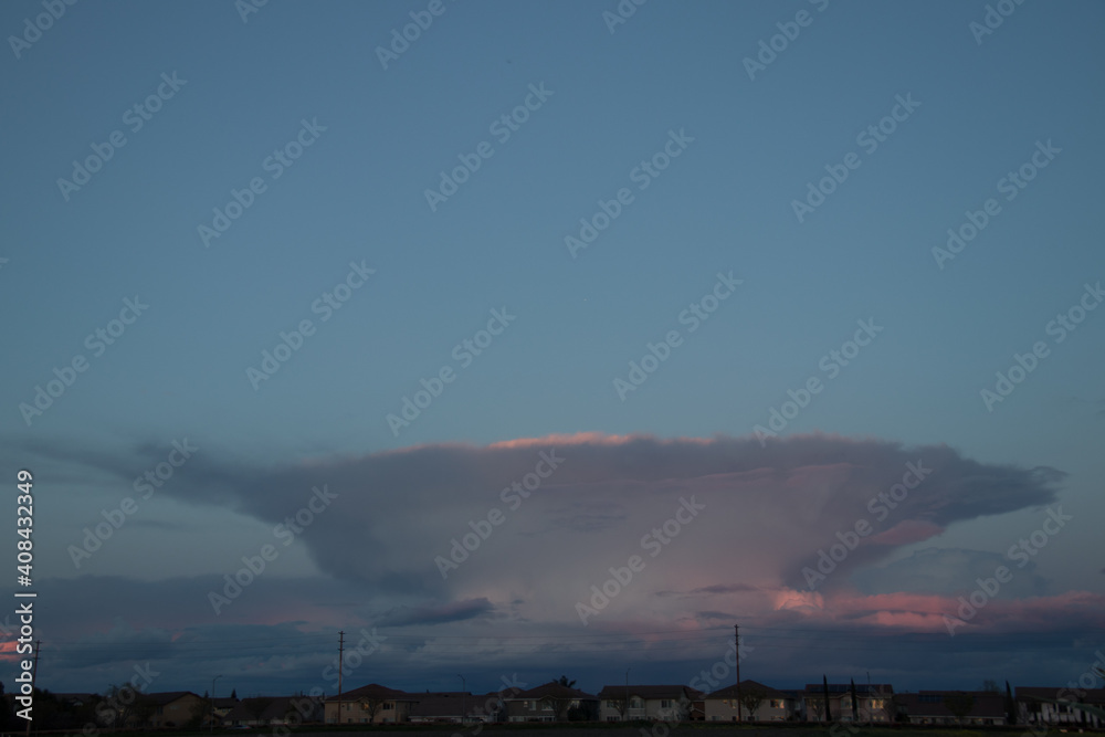 Cloud formation from an approaching storm over houses