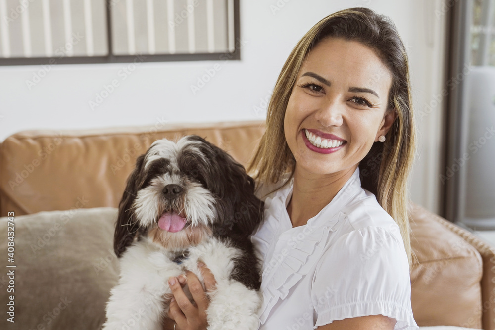 Portrait of beautiful Brazilian woman and her pet shih tzu dog at home, best friend, family love Portrait of beautiful Brazilian woman and her pet shih tzu dog at home, best friend, family love