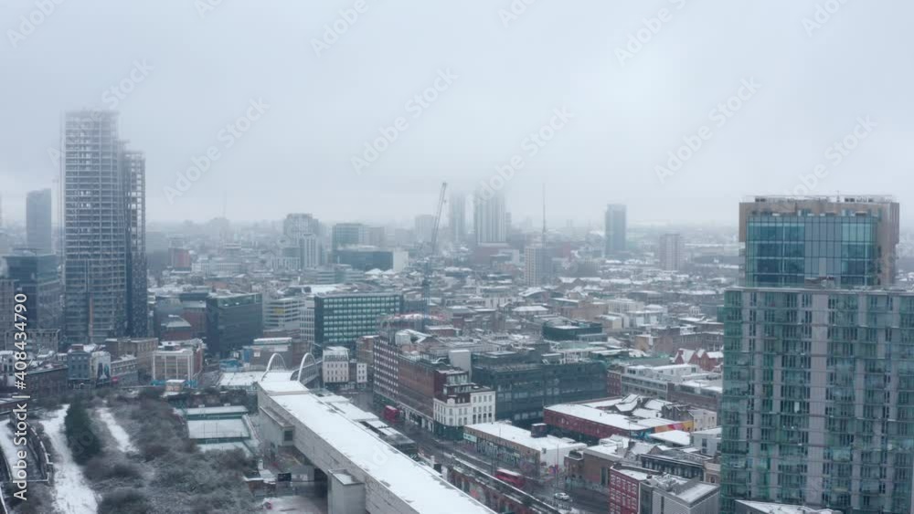 Stable aerial drone shot of shoreditch highstreet London covered in Snow Stable aerial drone shot of shoreditch highstreet London covered in Snow