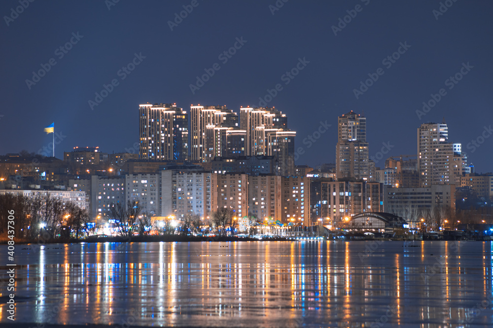 Obraz premium Beautiful city at night. Night city reflected in the water.