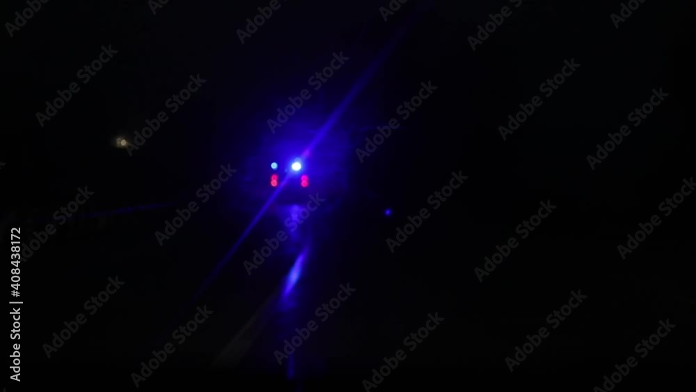 Parallel Moving of an Ambulance Vehicle with Working Strobe Light and Signal Driving to Emergency Call on a country road at Night. Shot from other car Parallel Moving of an Ambulance Vehicle with Working Strobe Light and Signal Driving to Emergency Call on a country road at Night. Shot from other car