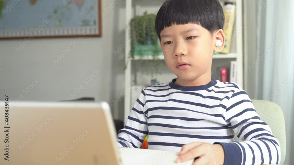 Young smart looking Asian student boy present his drawing to teacher via computer tablet in online learning classroom. Study at home, New normal in technology and education during Covid-19 lockdown Young smart looking Asian student boy present his drawing to teacher via computer tablet in online learning classroom. Study at home, New normal in technology and education during Covid-19 lockdown