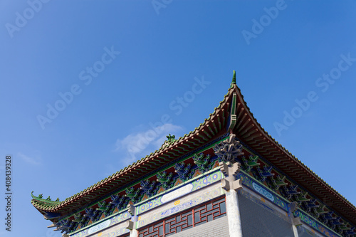 Roof of ancient Chinese Architecture, Old building under blue sky. © Holmessu