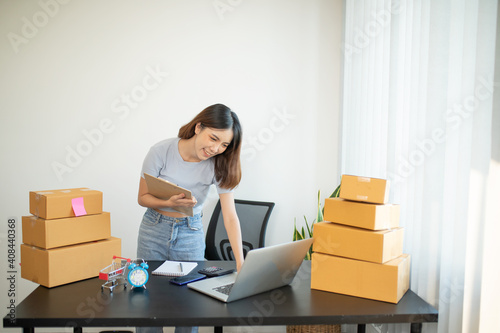 Asian teenager owner business woman work at home for online shopping and SME sale.