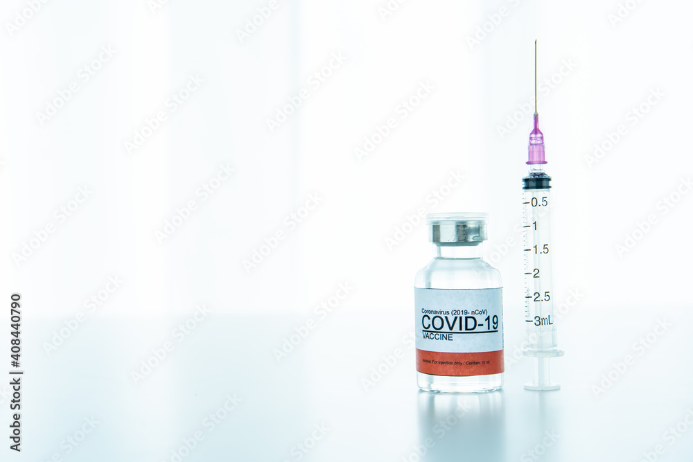 Coronavirus 2019-nCoV or COVID-19 cure vaccine and syringe with copyspace. Coronavirus 2019-nCoV or COVID-19 cure vaccine and syringe with copyspace.