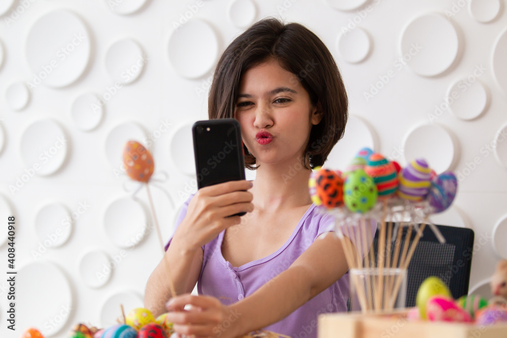 Asian young pretty woman enjoy painting a water colors on fantasy eggs for Easter egg festival. Asian young pretty woman enjoy painting a water colors on fantasy eggs for Easter egg festival.
