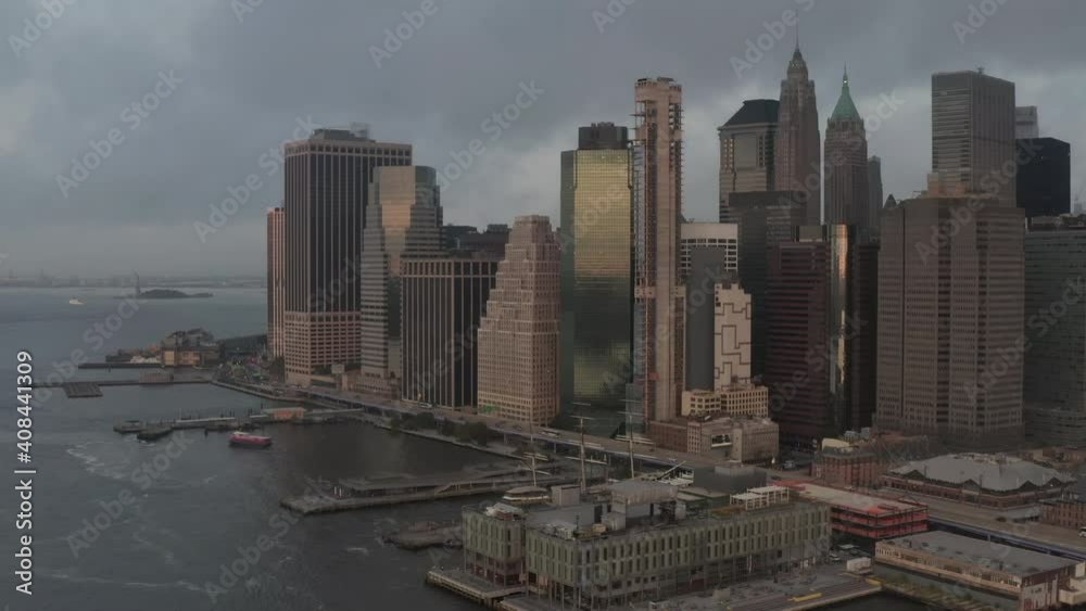 Office Buildings in a Big City by the River, East River with Manhattan, New York City Skyline at Dawn with Cloudy Overcast Sky, Aerial View Office Buildings in a Big City by the River, East River with Manhattan, New York City Skyline at Dawn with Cloudy Overcast Sky, Aerial View