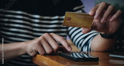 Man holding credit card and typing on smartphone for online shopping and payment makes a purchase on the Internet, Online payment, Business financial and technology.
