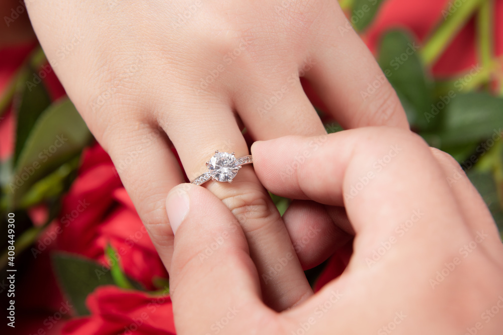 groom wears ring on bride's finger in wedding ceremony