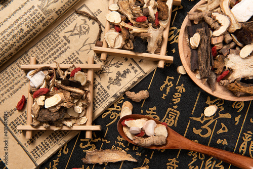 Chinese herbal medicine selection on calligraphy background photo