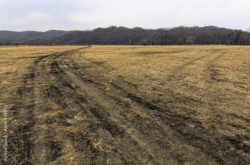 Tire marks in the field, detail of footprints in the field. car footprint Tire marks in the field, detail of footprints in the field. car footprint
