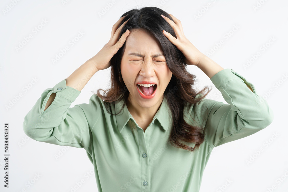 Portrait of a beautiful Asian businesswoman holding her head and screaming Portrait of a beautiful Asian businesswoman holding her head and screaming