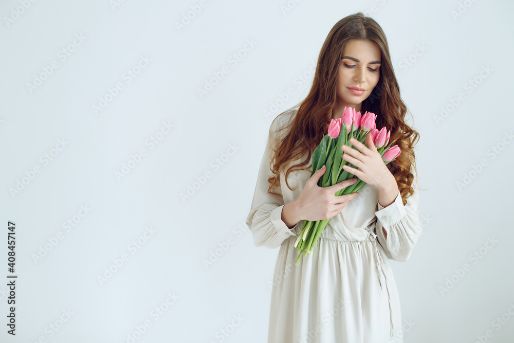 Beautiful woman with tulips. Spring bouquet in the hands of a young and happy girl. High quality photo. Beautiful woman with tulips. Spring bouquet in the hands of a young and happy girl. High quality photo.
