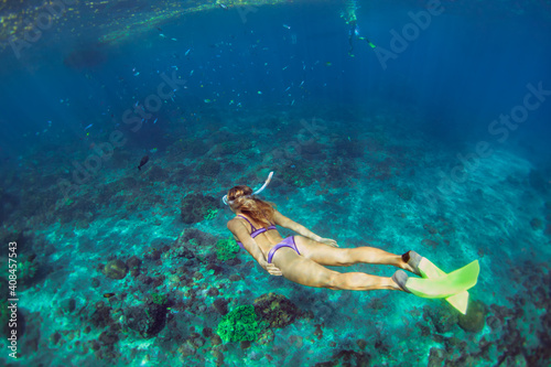 Active teenage girl jump, dive underwater in tropical coral reef pool. Travel lifestyle, water sport, snorkeling adventure. Swimming lessons on summer sea beach vacation with kids