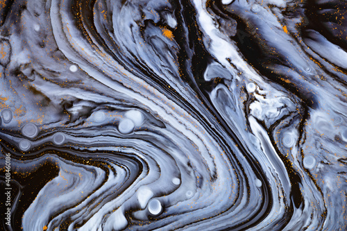 Fluid art texture. Backdrop with abstract swirling paint effect. Liquid acrylic picture with artistic mixed paints. Can be used for baner or wallpaper. Blue, black and white overflowing colors © Mirror Flow