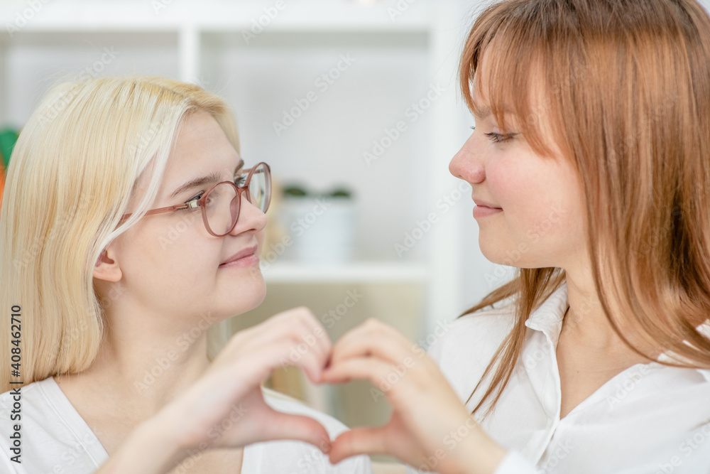 Two happy young girl show heart sign. LGBT concept Two happy young girl show heart sign. LGBT concept
