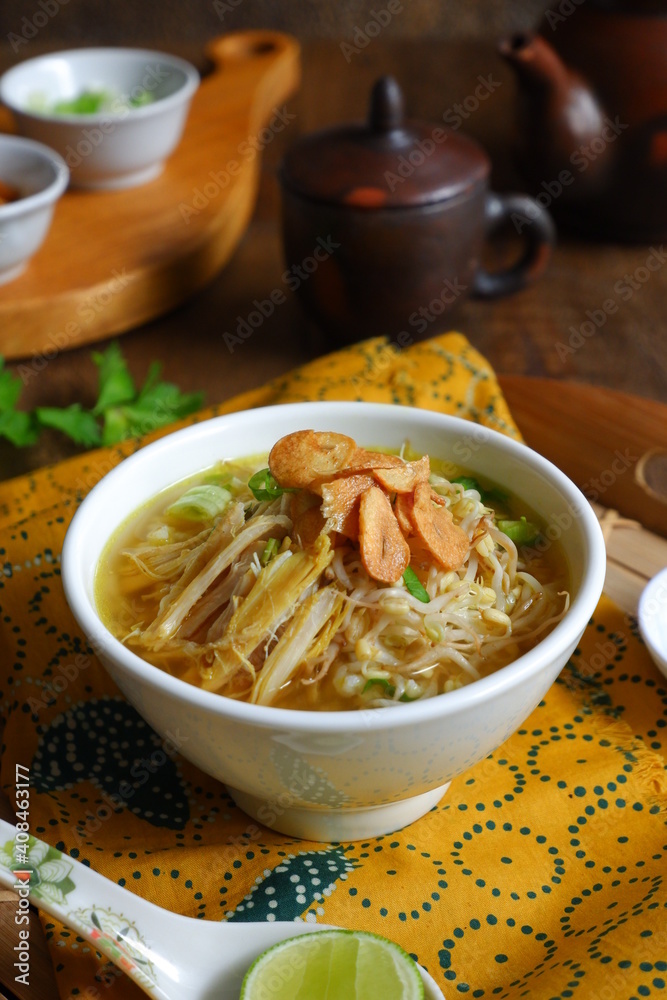 a bowl of Indonesian clear soup named soto Kudus, it contains of rice, vegetables and chicken meat a bowl of Indonesian clear soup named soto Kudus, it contains of rice, vegetables and chicken meat
