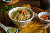 a bowl of Indonesian clear soup named soto Kudus, it contains of rice, vegetables and chicken meat