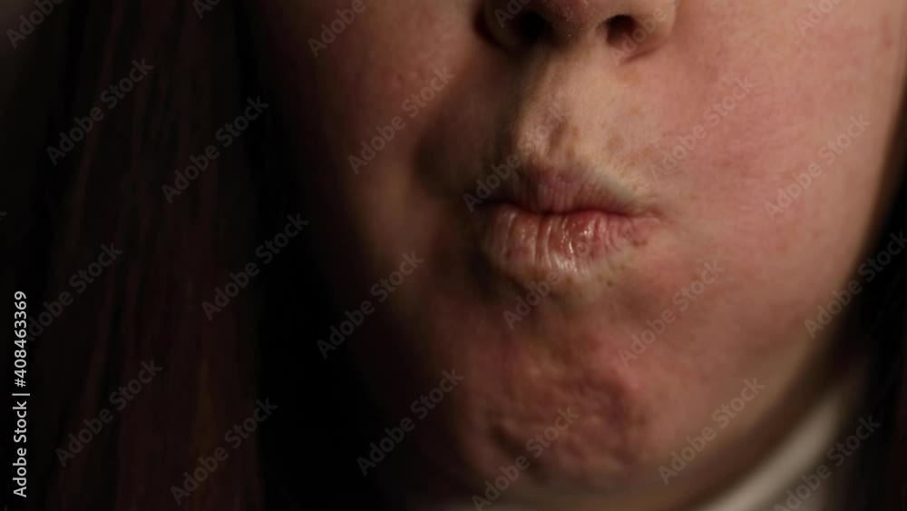 young woman with dark hair eating sweet rolls with chinese chopsticks close up