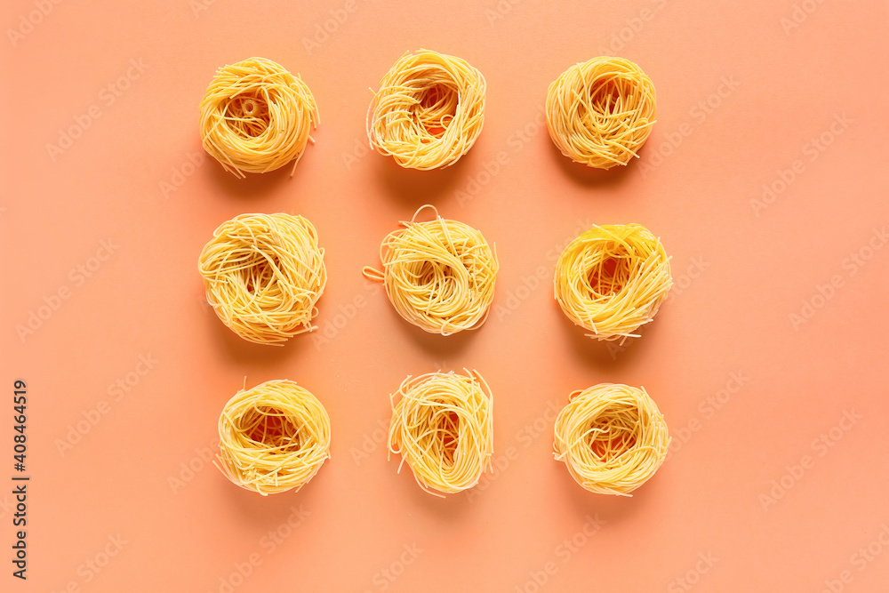 Dry pasta nests on color background Dry pasta nests on color background