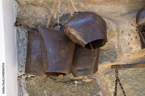 Slika na platnu Vintage cow bells on a stone wall background
