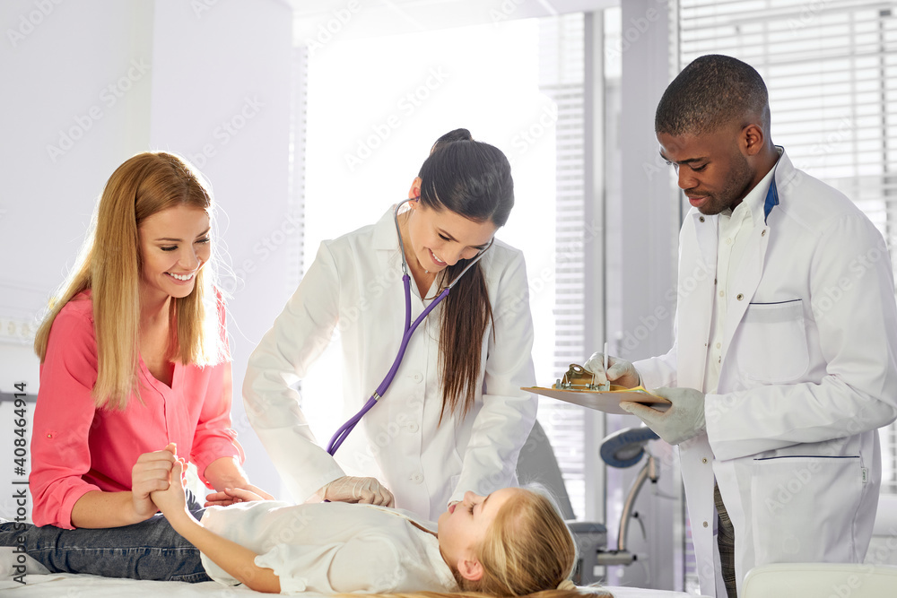 doctors examining health of girl patient, diverse african and caucasian doctors in suit treating caucasian teen girl lying on hospital bed, supportive mother sits near her doctors examining health of girl patient, diverse african and caucasian doctors in suit treating caucasian teen girl lying on hospital bed, supportive mother sits near her