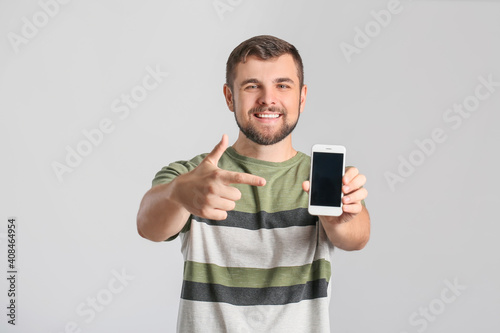 Young man with mobile phone...