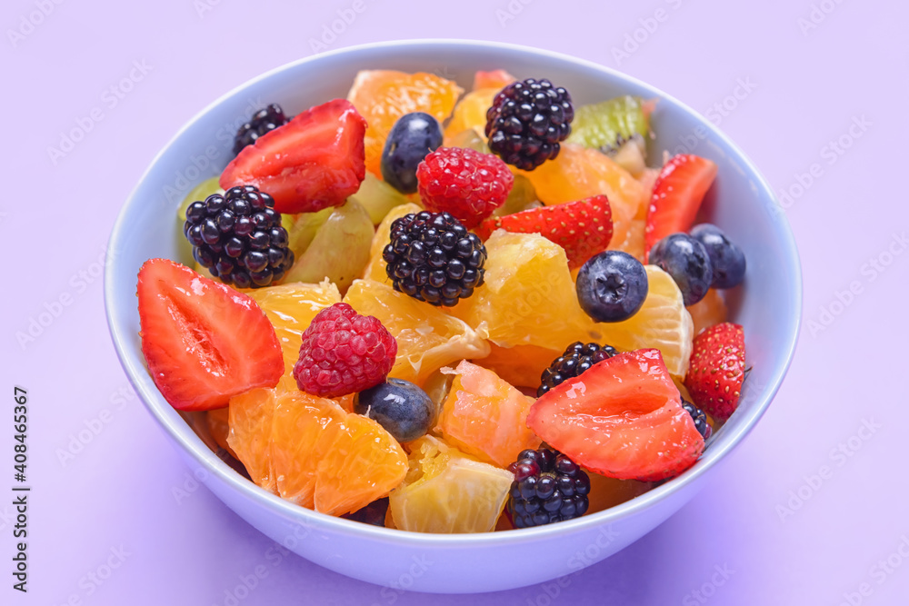 Bowl with fruit salad on color background Bowl with fruit salad on color background
