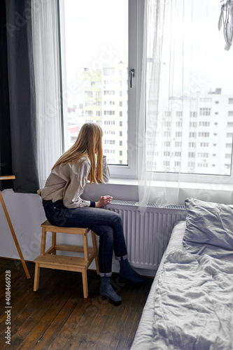 Free Download woman sitting on chair and looking at window outside expecting someone - GFXLoad