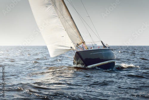 Canvas Print Heeled sloop rigged yacht sailing in an open Baltic sea on a clear day