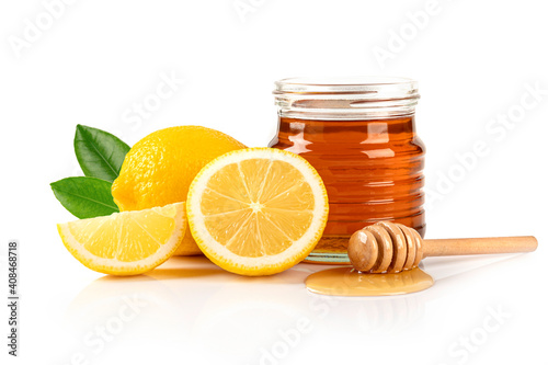 Honey with lemon and leaves on white background. photo