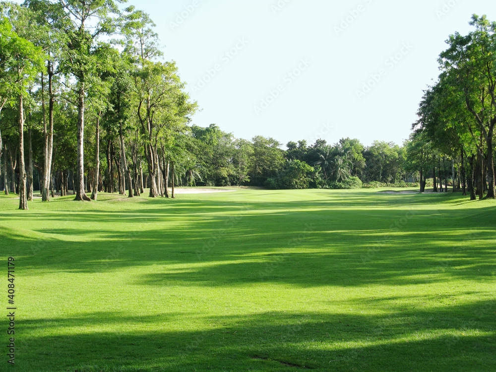 Background of evening golf course has sunlight shining down at golf course in Thailand. Nice scenery on a golf course at a late summer. Background of evening golf course has sunlight shining down at golf course in Thailand. Nice scenery on a golf course at a late summer.