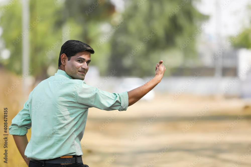 Fototapeta premium Young indian man asking lift for going to home