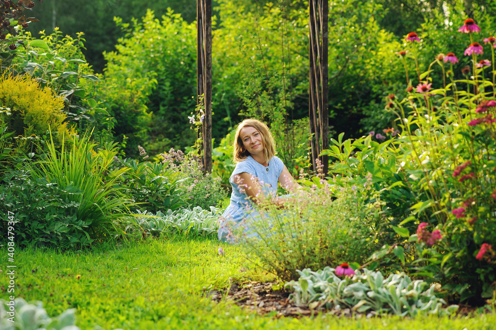 woman gardener relaxing in summer on green lawn woman gardener relaxing in summer on green lawn