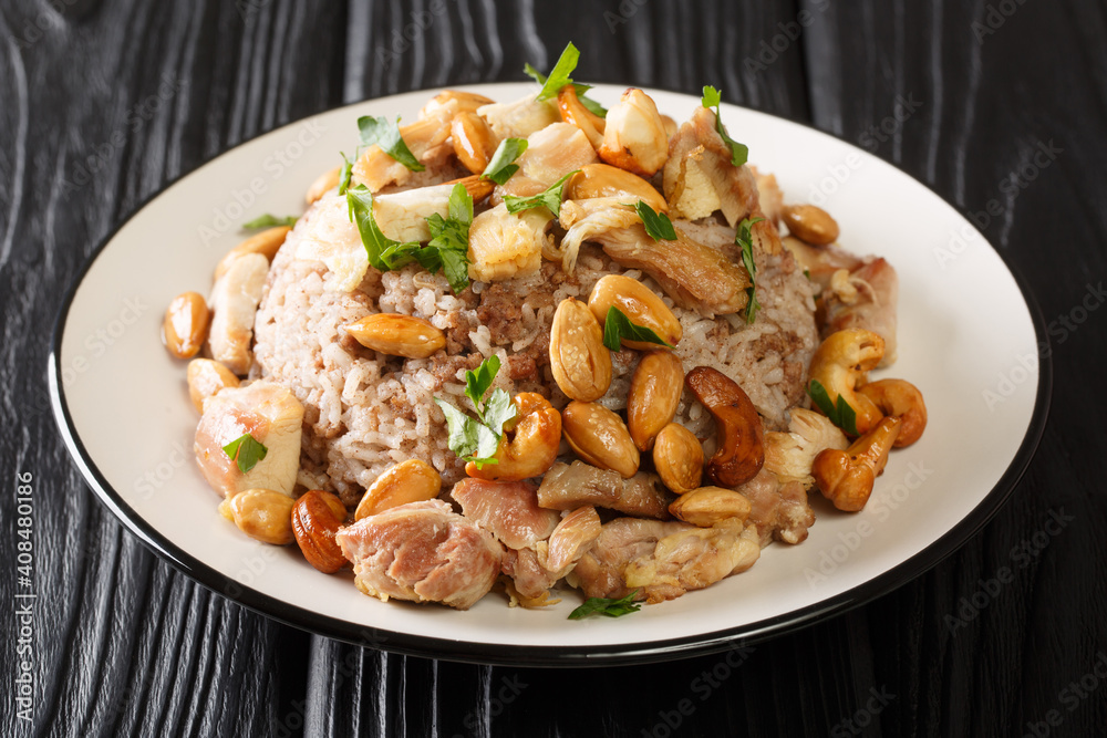 Traditional Lebanese cinnamon rice and chicken dish is called Riz bi-Djaj closeup in the plate on the table. horizontal Traditional Lebanese cinnamon rice and chicken dish is called Riz bi-Djaj closeup in the plate on the table. horizontal