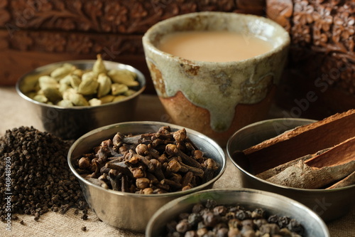 Fototapeta Naklejka Na Ścianę i Meble -  インドのチャイでリラックス。Relax time with Indian Chai(Tea) and Variety of spices on a old wooden table