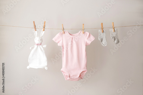 Baby clothes hanging on the rope.