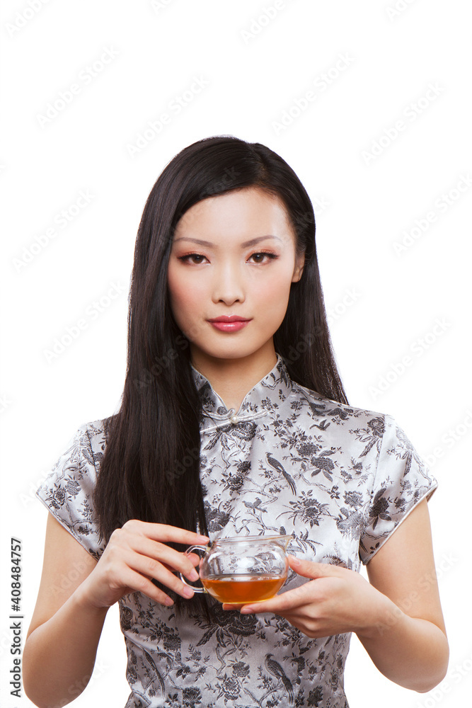 Wear cheongsam Oriental young female holding a teapot Wear cheongsam Oriental young female holding a teapot