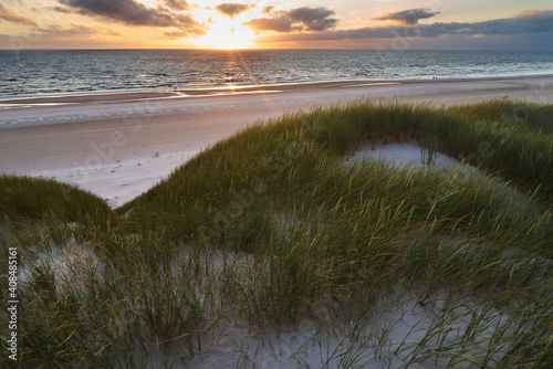scenic sunset over the north sea behind idyllic sand dunes during summer - location: Vejers Strand, Denmark