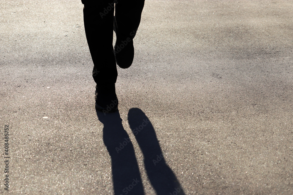 Silhouette of person running the street, runner shadow on pavement. Woman  in sneakers runs on sidewalk, concept for jogging, healthy lifestyle Stock  Photo | Adobe Stock