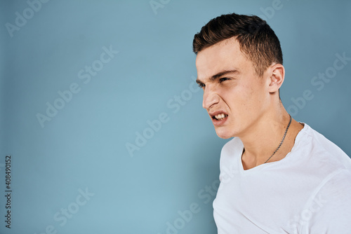 Man gestures with his hands emotions white t-shirt expression blue background